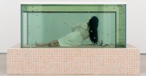 dreamlike aquarium of ‘kissing fish’ ends up being a chamber to lie within